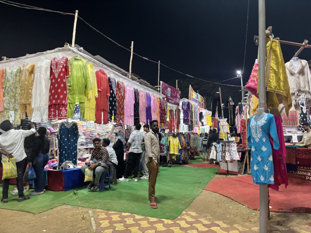 Vibrant dresses and fabrics displayed at the Hyderabad Numaish event.