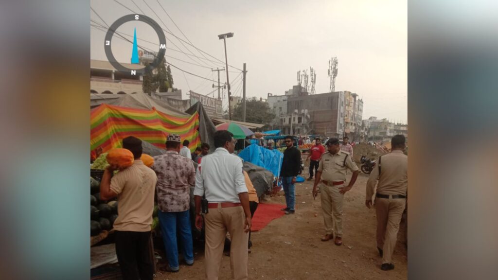 Market scene at The Siasat Daily event in Hyderabad, with vendors and police presence.