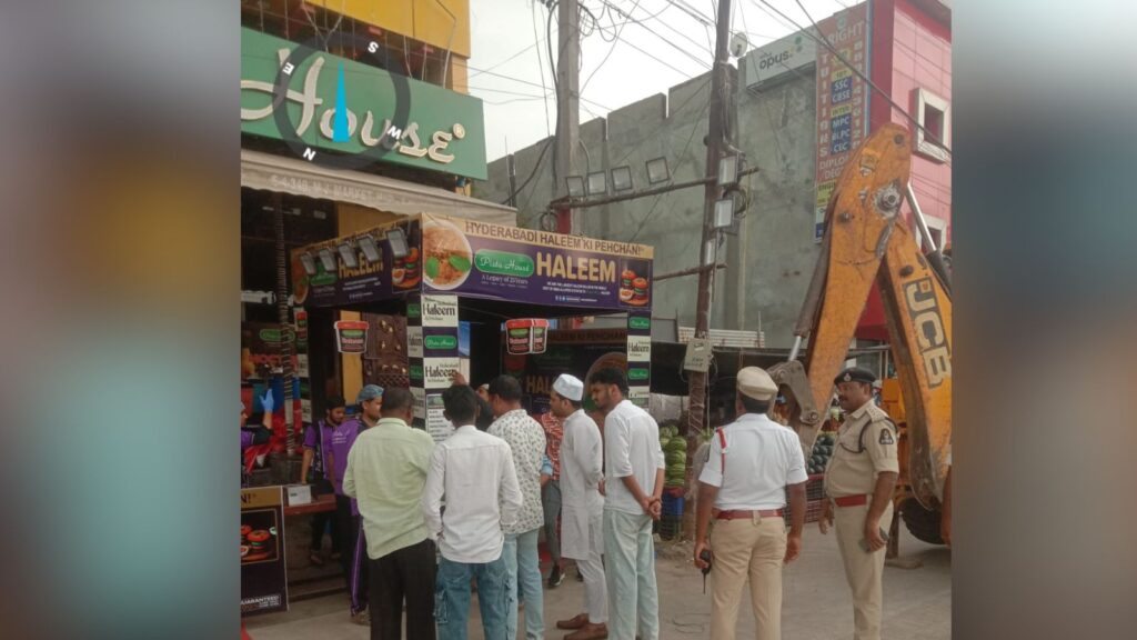 Construction site with workers and police officers on a busy street.