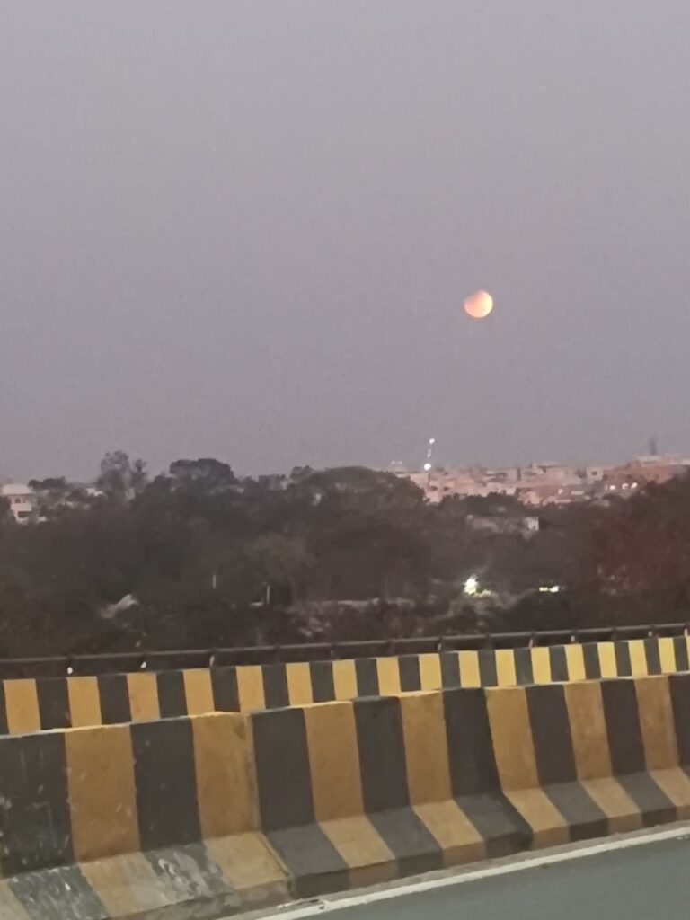 Blood moon rising over Hyderabad skyline during lunar eclipse 2026.