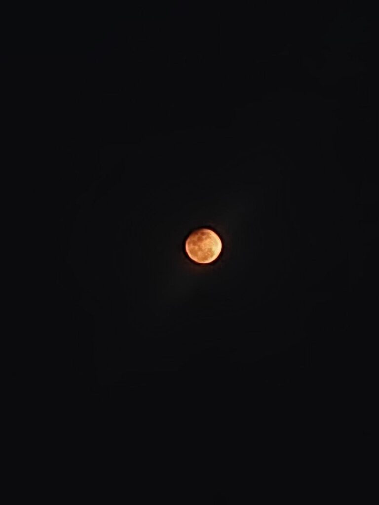 Blood moon during total lunar eclipse 2026 illuminating Hyderabad sky with a reddish hue.