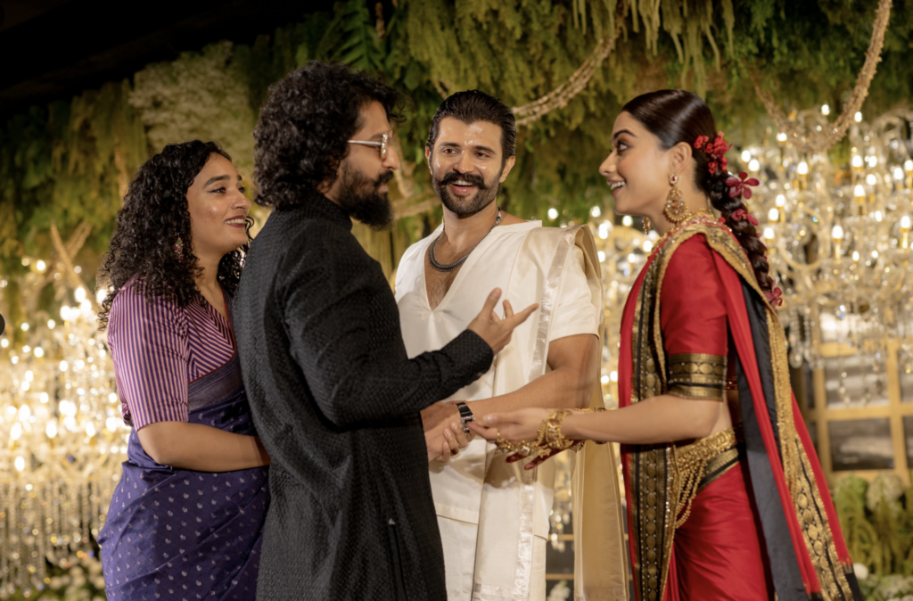A group of friends, including a woman in traditional Indian attire, enjoying a festive outdoor event with.
