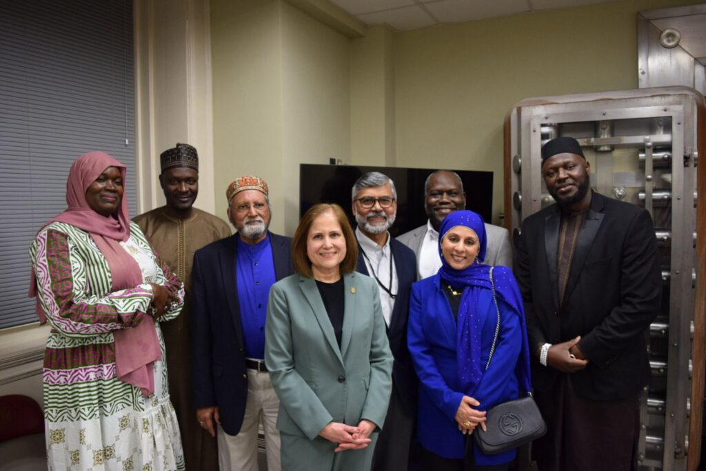 Group of diverse individuals, including a Hyderabadi, at Virginia's Ramzan event, celebrating cultural un.