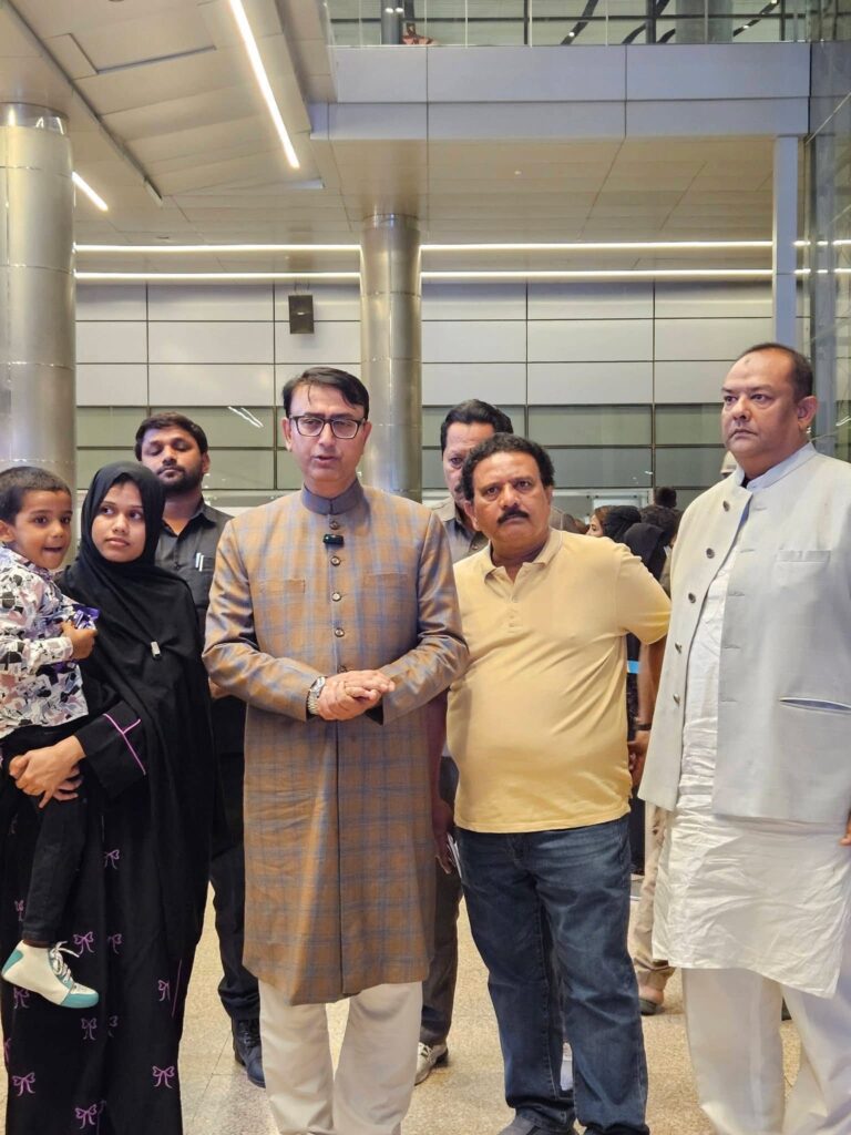 Ameena Begum (left) stands beside MBT spokesperson Amjed Ullah Khan at Hyderabad airport after her return.