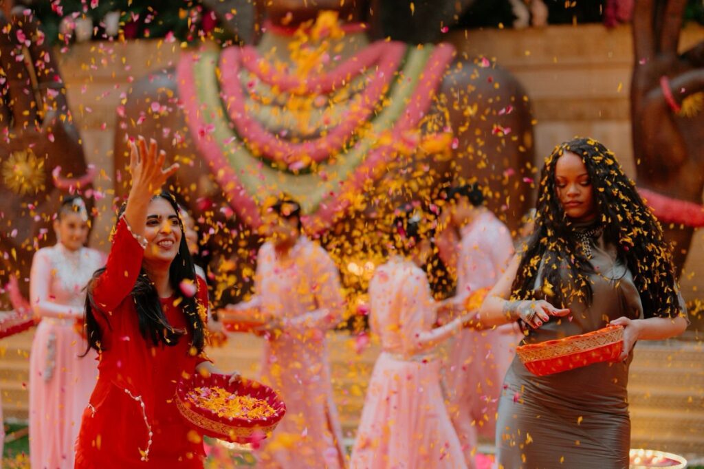 Women celebrating Holi with coloured powder and joyful expressions.