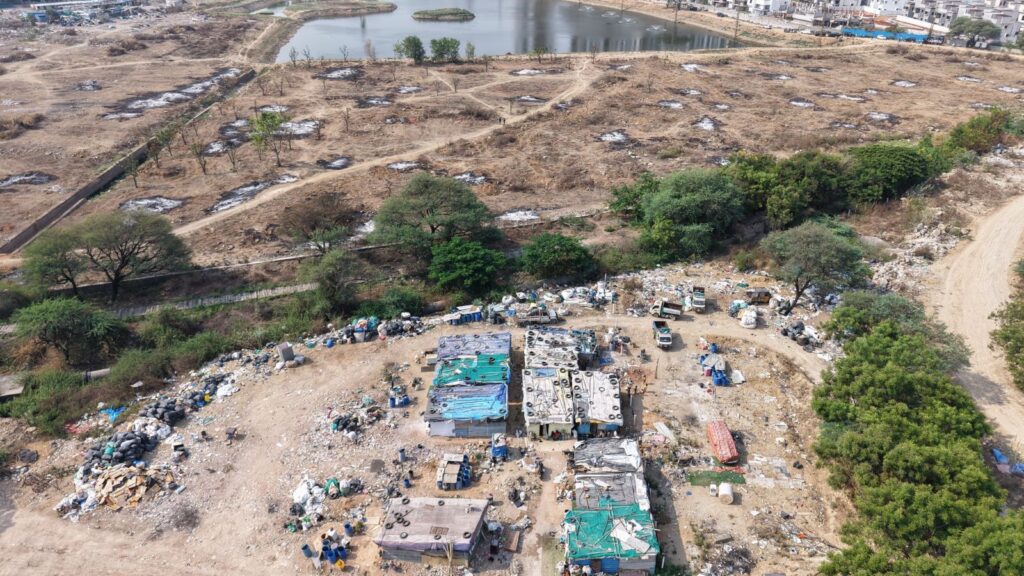 Aerial view of Muskin Cheruvu FTL with eviction notices issued by Hydraa to residents within 10 days.