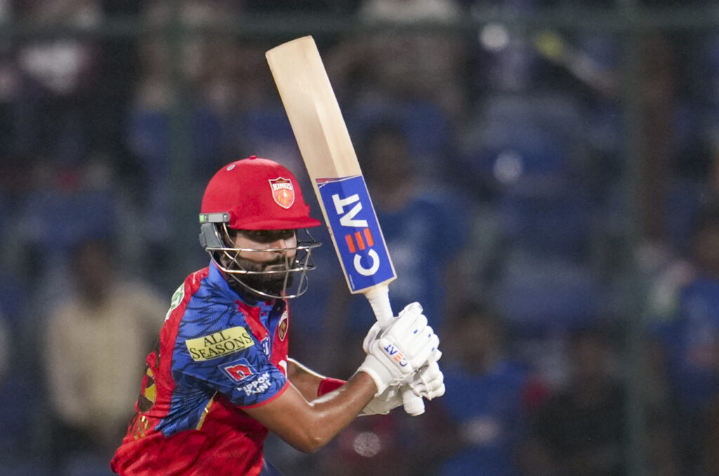 Sunrisers Hyderabad batsman in red and blue uniform hitting a six in IPL match.