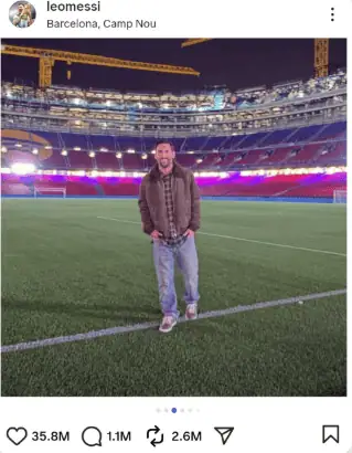 A man standing on a football field at Camp Nou stadium during night, illuminated with vibrant lights, cel.