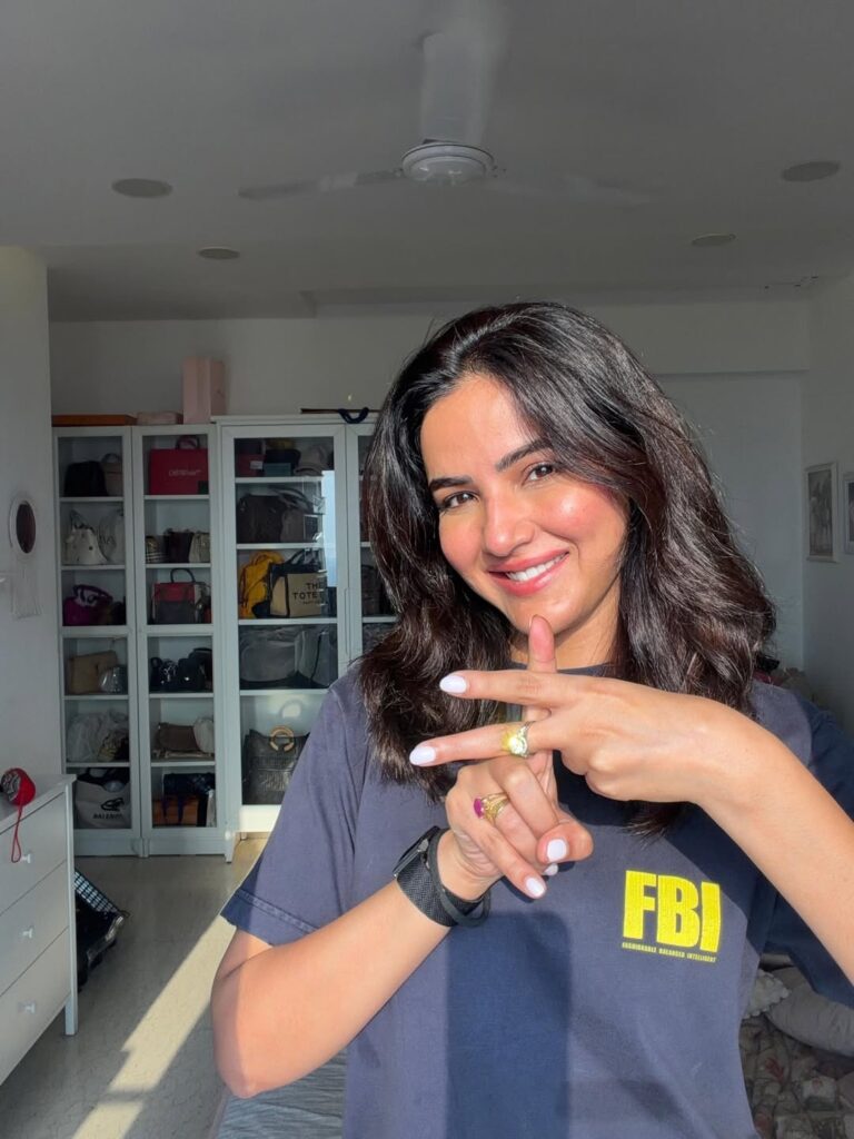 Female contestant of Khatron Ke Khiladi 15 in FBI T-shirt smiling and posing indoors.