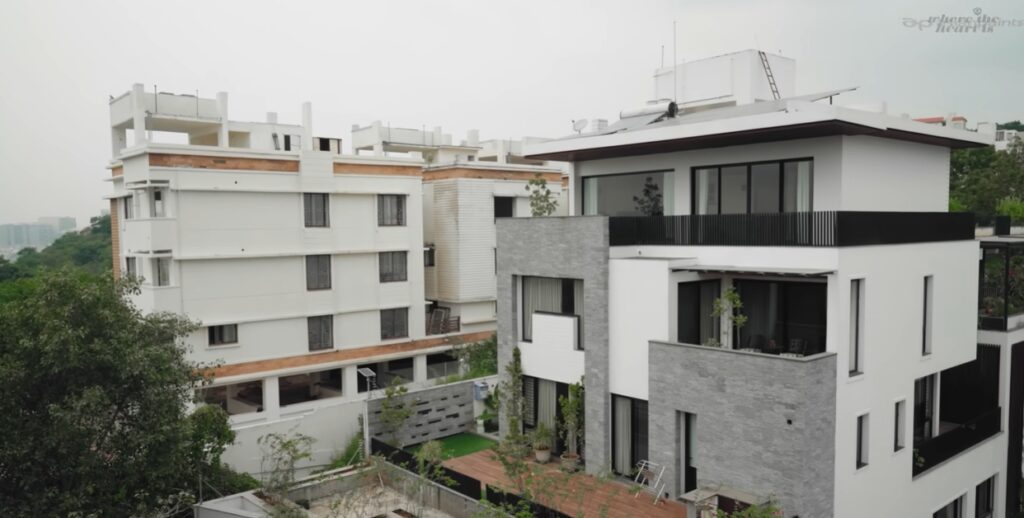 Elegant modern house built on a hill in Hyderabad, showcasing contemporary architecture and scenic surrou.