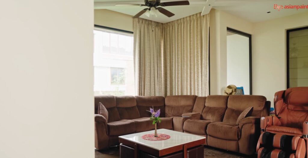 Elegant living room with plush brown sofa and large windows.