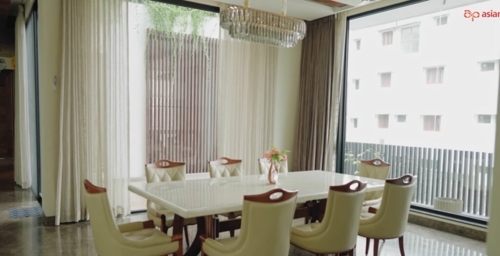 Elegant dining room with large windows and modern decor.