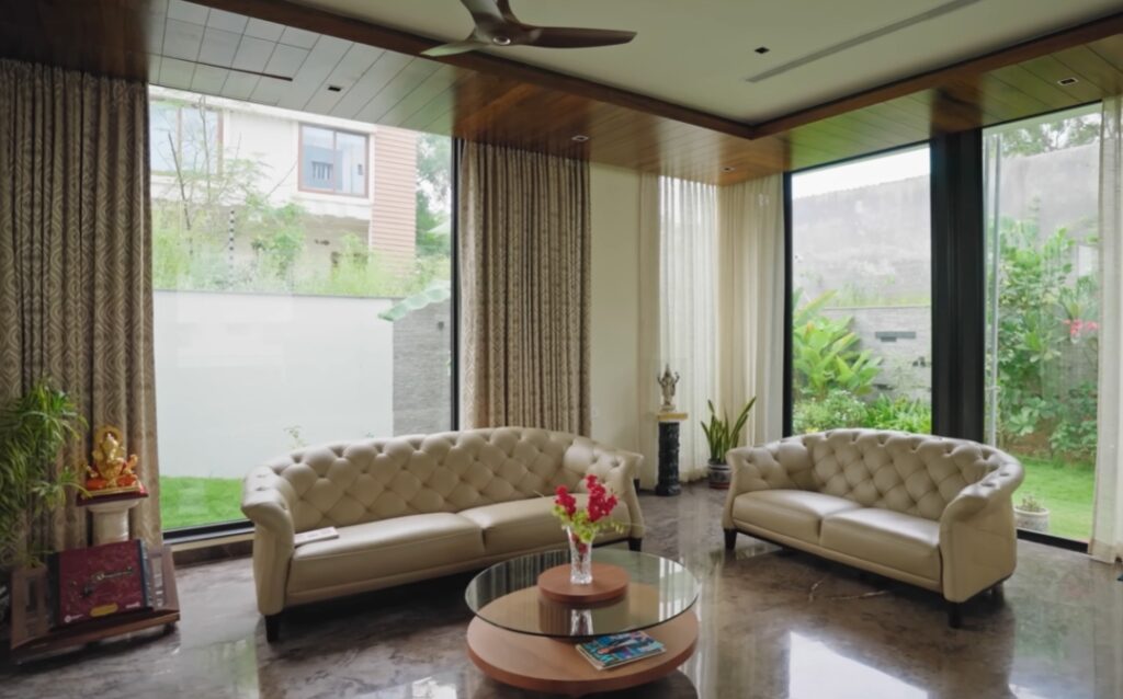 Elegant living room with large glass windows and modern decor.