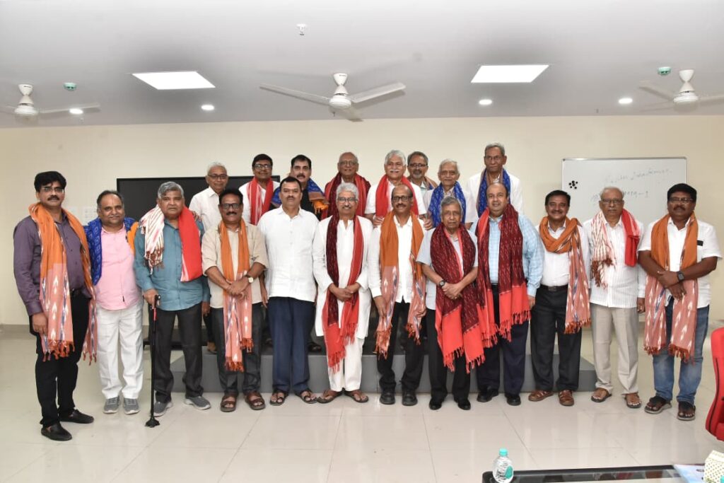 Group of Indian political leaders and officials posing together in a conference room.