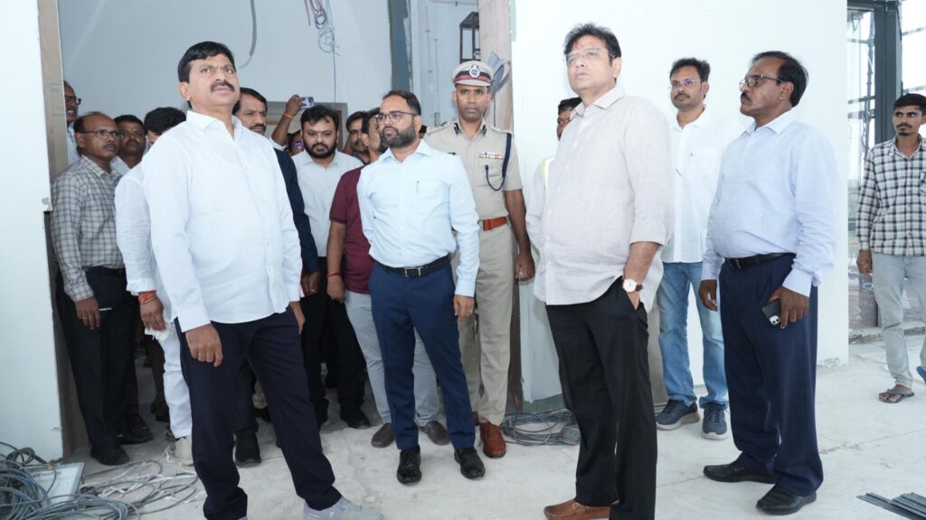 Group of officials and professionals inspecting a construction site or facility indoors.
